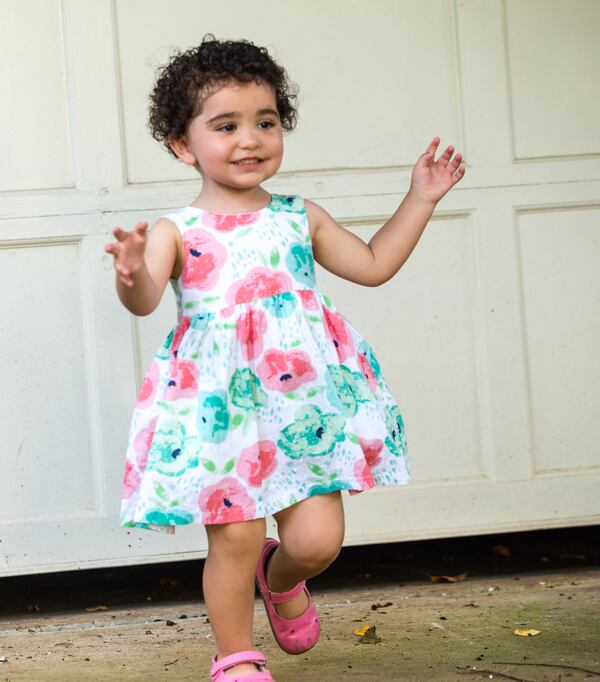 2-year-old Simone Mize-Gregg was recently declared a U.S. citizen by a U.S. district court judge. Simone is seen playing in her front yard with her family on Friday, Sept 4, 2020.  (Jenni Girtman for The Atlanta Journal-Constitution)