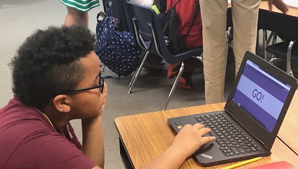 Jenkins Elementary School student Marcus Campbell, 10, gets back to work. He’s one of about 1,500 Gwinnett County students participating in the school district’s Math Institute. ERIC STIRGUS / ESTIRGUS@AJC.COM