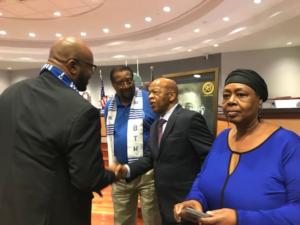 U.S. Rep. John Lewis, center, greets audience members in the Atlanta school board audience before the school board's Sept. 3, 2019, meeting. VANESSA McCRAY/AJC