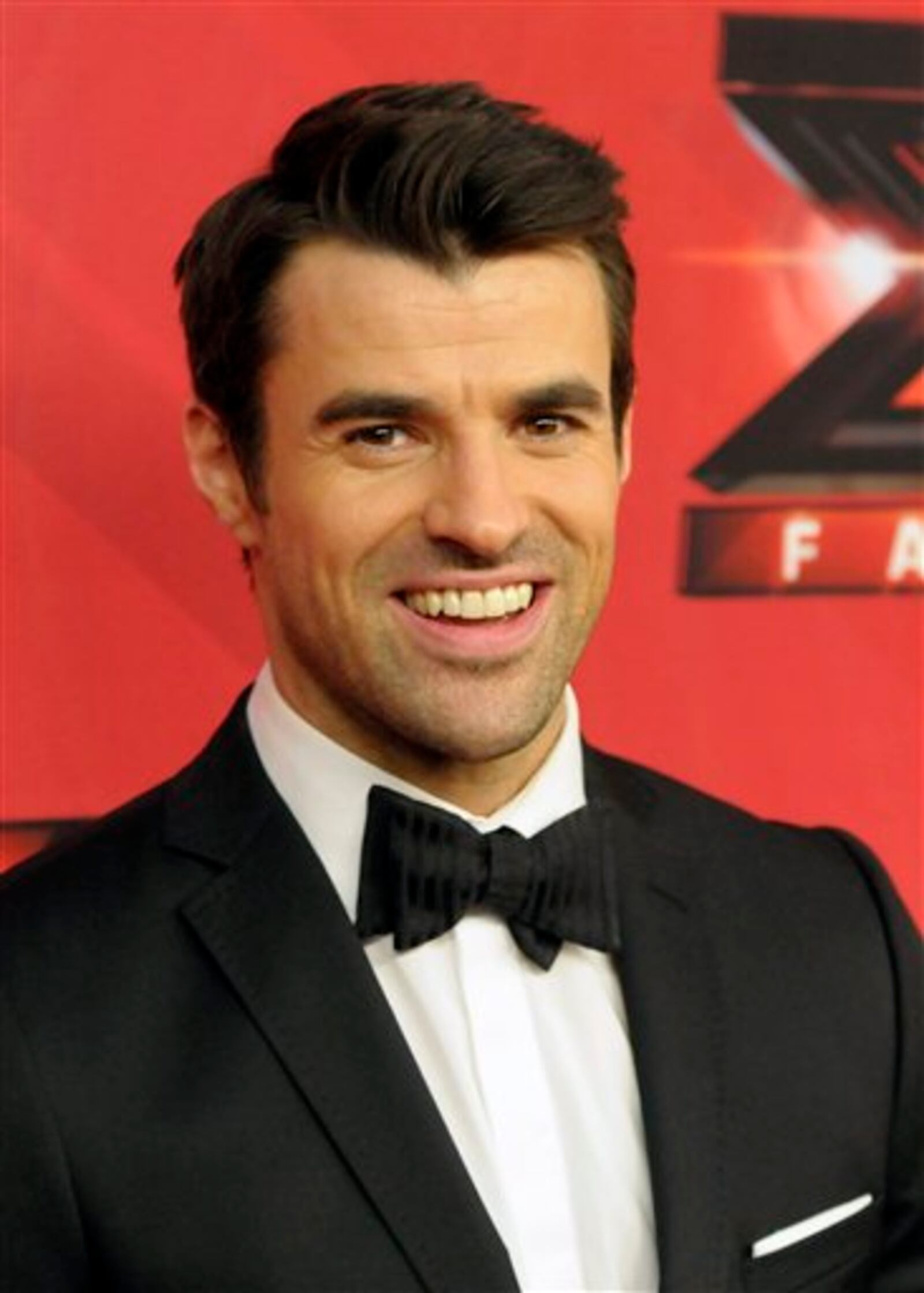 FILE - In this Dec. 22, 2011 file photo, television host Steve Jones poses on the red carpet at "The X Factor" Finale show in Los Angeles. Jones said on Twitter on Monday, Jan. 30, 2012, that he wouldnt be returning to host the shows second season. (AP Photo/Dan Steinberg, file)