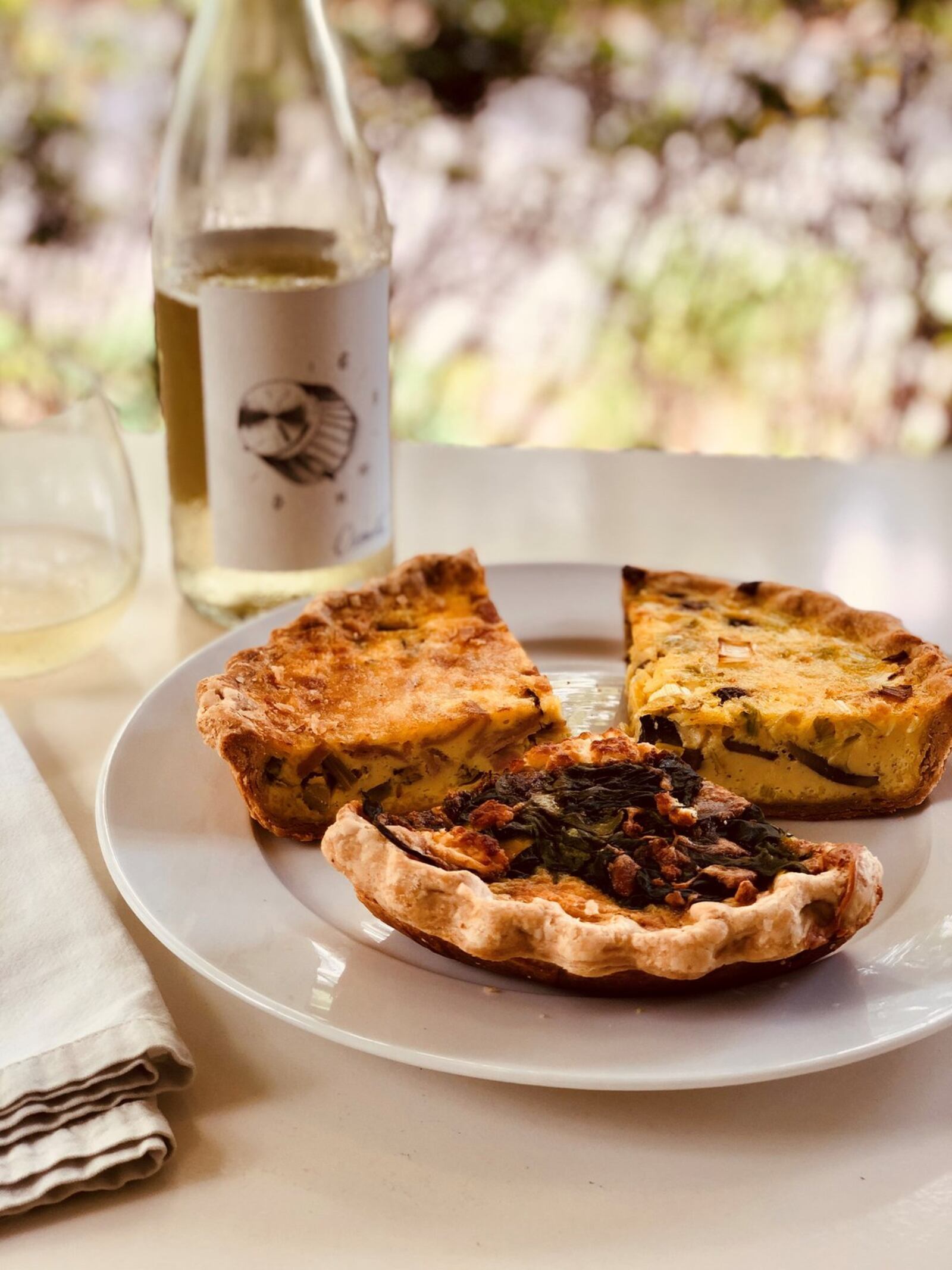 A trio of quiche slices from Cafe Lapin: (clockwise from upper left) ham and asparagus; mushroom and leek; tomato, spinach and goat cheese. CONTRIBUTED BY WENDELL BROCK