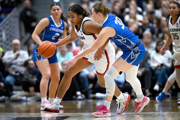 UConn forward Sarah Strong, left, steals the ball from Creighton guard Morgan Maly in the first half of an NCAA college basketball game, Thursday, Feb. 27, 2025, in Hartford, Conn. (AP Photo/Jessica Hill)