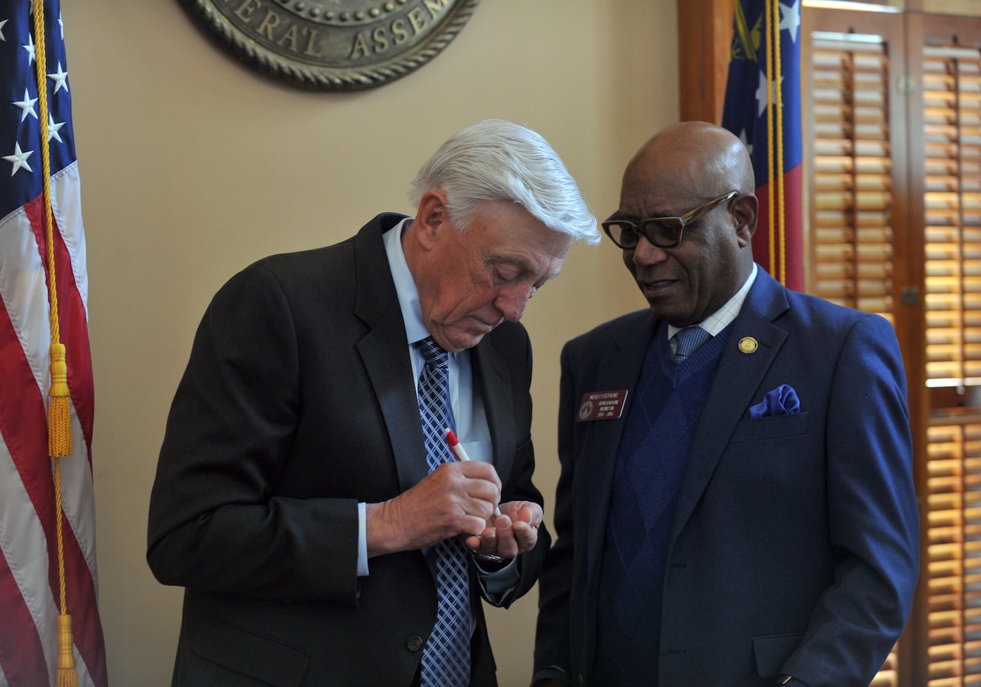 Former Major League pitcher and Hall of Famer Phil Niekro, left, autographs a piece of paper for Rep. Mickey Stephens D- Savannah. Niekro was honored by the House Tuesday January 21, 2014. Niekro spent most of his career with the Braves organization, starting with the Milwaukee Braves in 1964. Niekro left the Braves in 1983 for stints with the New York Yankees, Cleveland Indians and the Toronto Blue Jays. In 1987 the Braves brought Niekro back, allowing him to retire as an Atlanta Brave. BRANT SANDERLIN /BSANDERLIN@AJC.COM