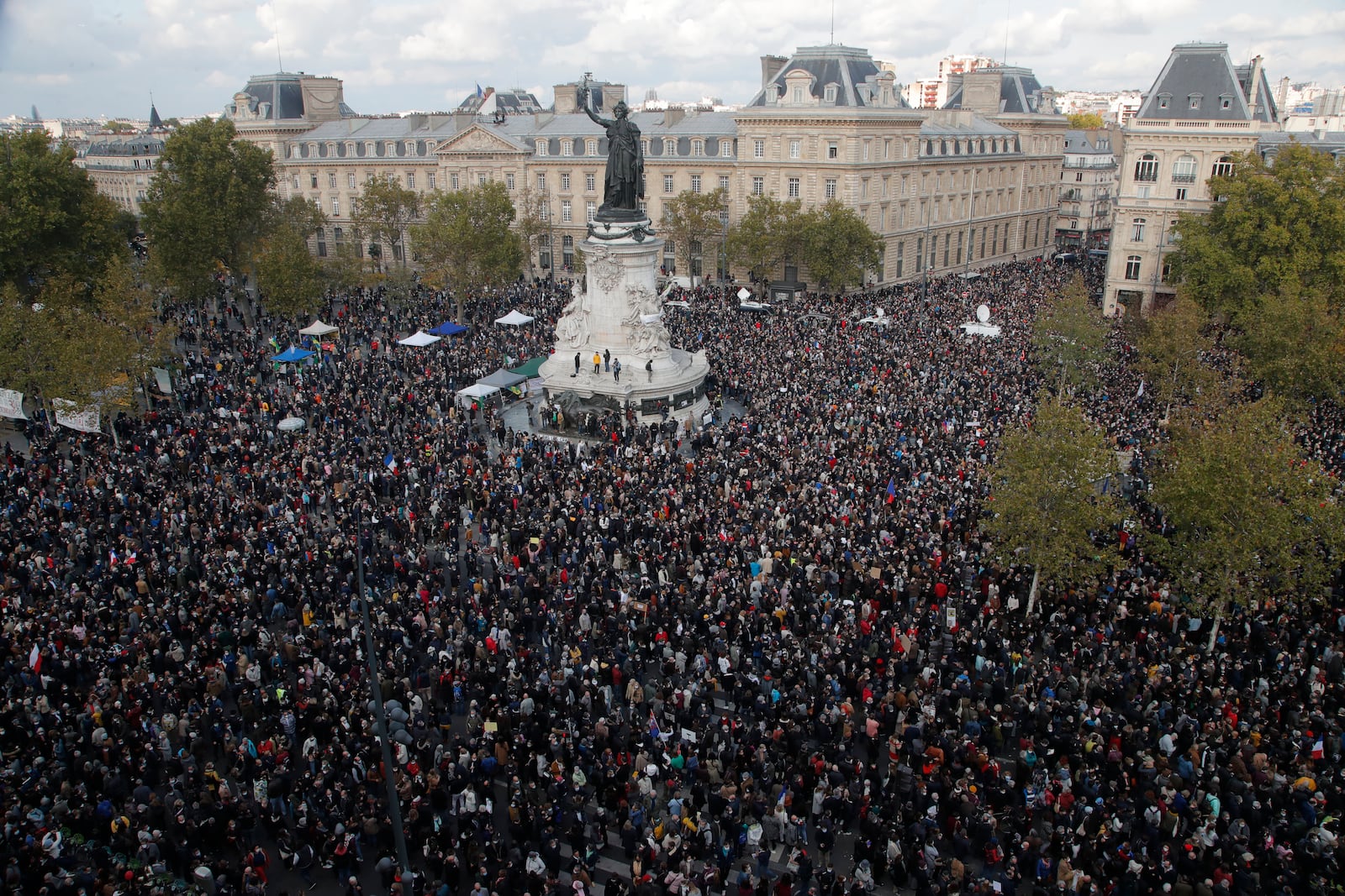 FILE - Hundreds of people gather on Republique square during a demonstration Sunday Oct. 18, 2020 in Paris, in support of freedom of speech and to pay tribute to French history teacher Samuel Paty. (AP Photo/Michel Euler, File)