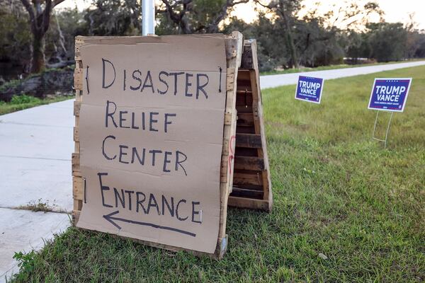 Election signage goes up outside of the FEMA Disaster Relief Center which is being converted to a polling location for the general election on Monday, Nov. 4, 2024, in Ridge Manor, Fla. (AP Photo/Mike Carlson)