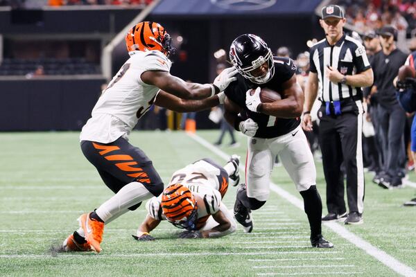  Falcons running back Bijan Robinson (7) is pushed out of bounds during the first half in an exhibition game against the Cincinnati Bengals at Mercedes-Benz Stadium on Friday, August 18, 2023, in Atlanta.
Miguel Martinezmiguel.martinezjimenez@ajc.com