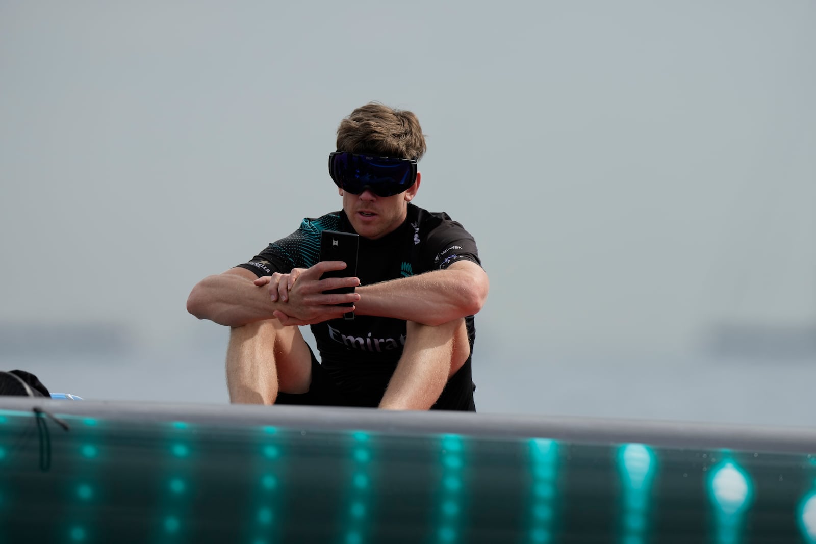 Emirates Team New Zealand skipper Peter Burling checks a screen before the Louis Vuitton 37th America's Cup race in Barcelona, Spain, Saturday, Oct. 12, 2024. (AP Photo/Bernat Armangue)