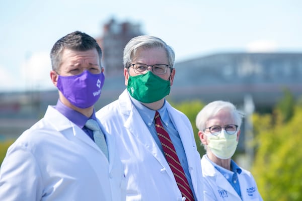 (From left) Dr. Danny Branstetter of Wellstar Health System; Dr.  Jim Fortenberry of Children’s Healthcare of Atlanta; and Sharon Pappas, chief nurse executive at Emory Healthcare, listen at a press conference near Mercedes-Benz Stadium in Atlanta, Georgia, on Thursday, August 19, 2021. (Rebecca Wright for the Atlanta Journal-Constitution)