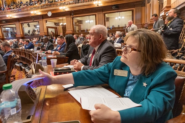 State Rep. Mandi Ballinger, a Republican from Canton, places a vote on the first day of the legislative session at the Capitol in Atlanta on Monday.