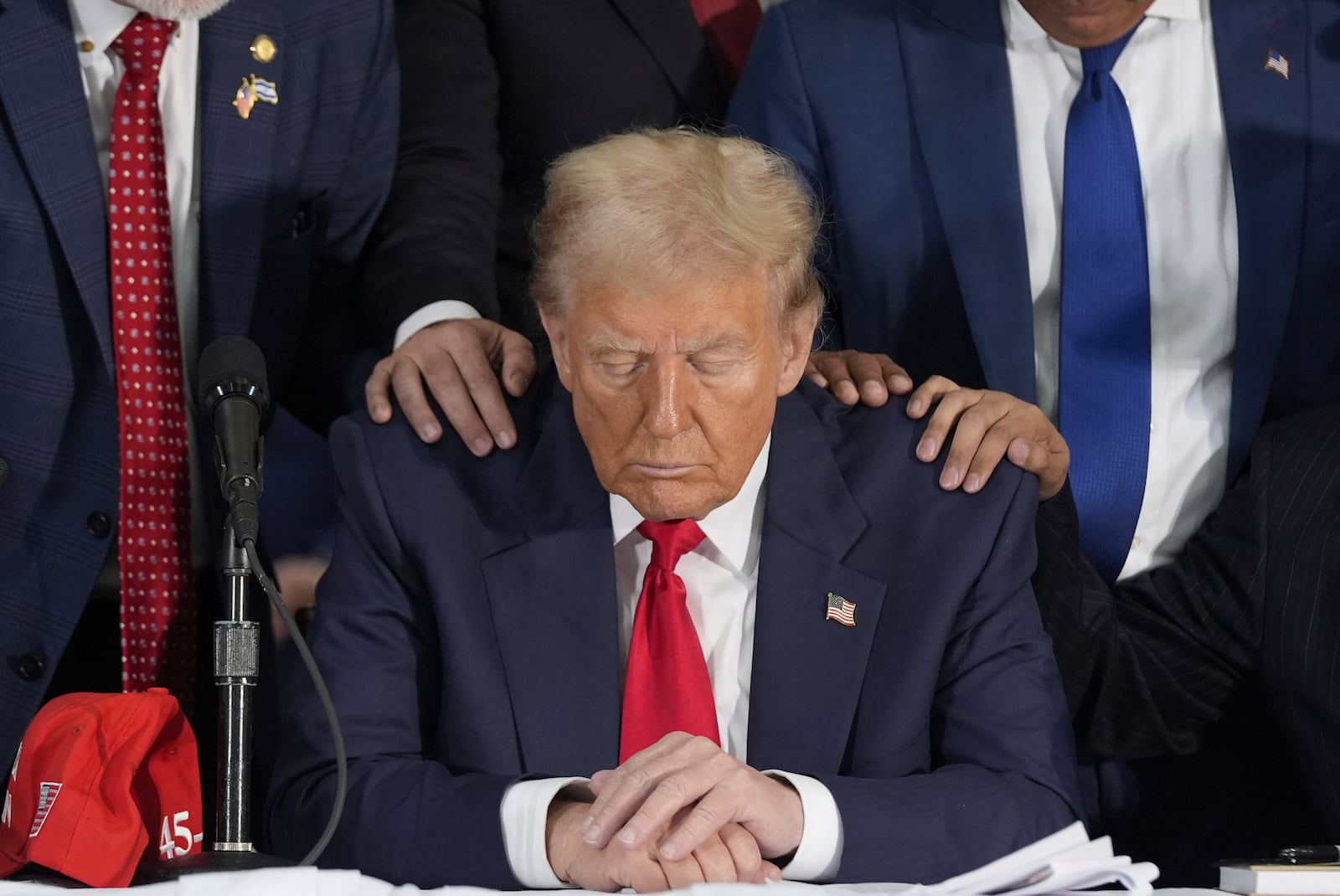 Latino leaders pray with Republican presidential nominee former President Donald Trump as he participates in a Latino leader roundtable, Tuesday, Oct. 22, 2024 in Doral, Fla. (AP Photo/Alex Brandon)