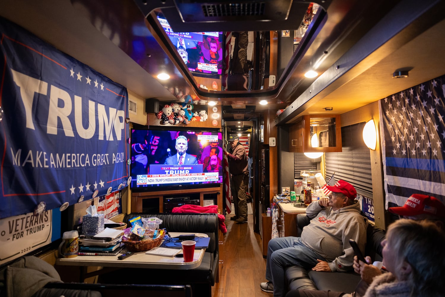 Members of a bus convoy from Georgia watch a Trump Rally live on Fox News at an RV park in College Park, Maryland on Sunday, January 19, 2025, one day before Donald Trump’s inauguration. (Arvin Temkar / AJC)