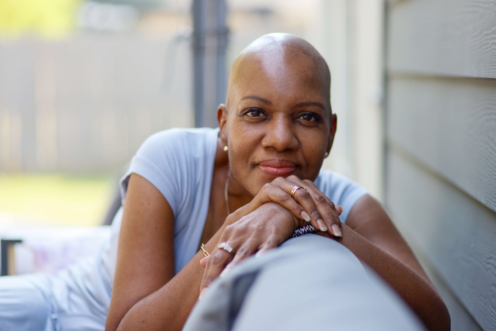 Monica Moody sits on her patio on Tuesday, Sept. 24, 2024. Moody, 55, was diagnosed with multiple myeloma, a blood cancer, in February. (Miguel Martinez/AJC)