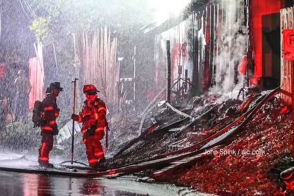 A garage that was converted to living space was destroyed in the fire on Apple Valley Road, according to DeKalb County fire officials. JOHN SPINK / JSPINK@AJC.COM