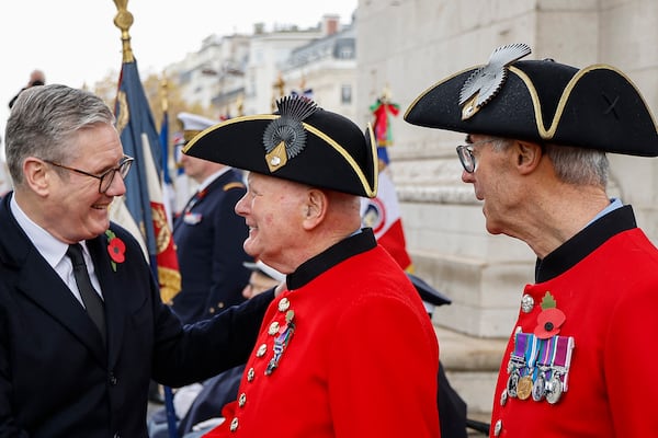 Britain's Prime Minister Keir Starmer greets Chelsea Pensioners during commemorations marking the 106th anniversary of the November 11, 1918, Armistice, ending World War I, at the Arc de Triomphe in Paris, Monday, Nov. 11, 2024. ( Ludovic Marin, Pool via AP)