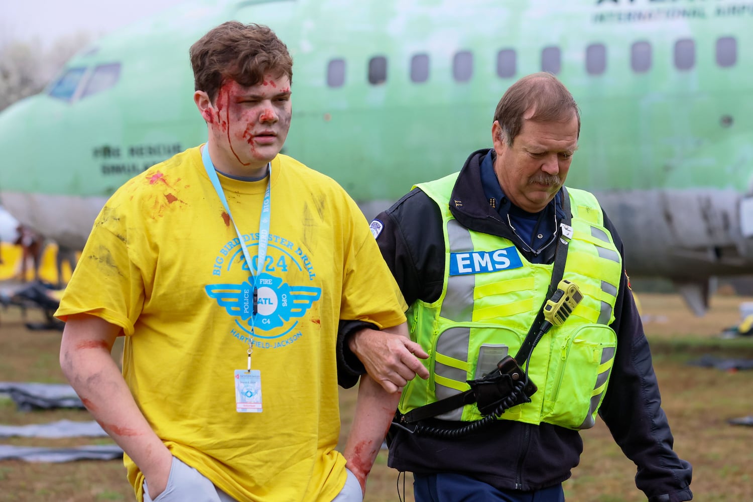 An EMS is assisting a fake victim during a full-scale disaster drill at Hartsfield-Jackson International Airport with Atlanta Firefighters, law enforcement, rescue personnel, and nearly 70 volunteers who participated in a triennial exercise known as “Big Bird” on Wednesday, March 6, 2024. Miguel Martinez /miguel.martinezjimenez@ajc.com