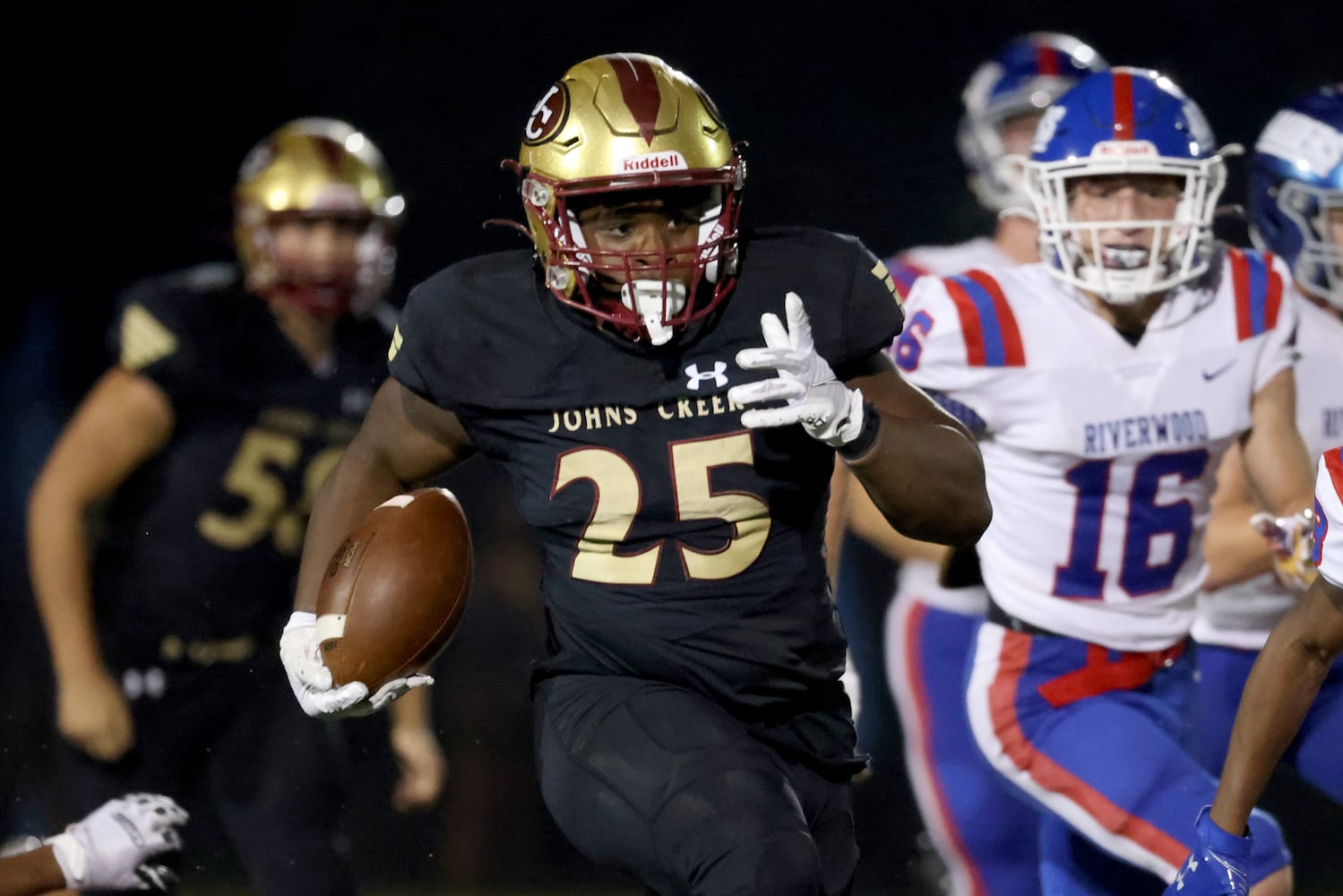 Sept. 24, 2021 - Johns Creek, Ga: Johns Creek running back Tylan Johnson (25) runs past Riverwood defensive back Zach Cigelske (16) for a long run during the second half at Johns Creek high school Friday, September 24, 2021 in Johns Creek, Ga.. Johns Creek won 40-32. JASON GETZ FOR THE ATLANTA JOURNAL-CONSTITUTION