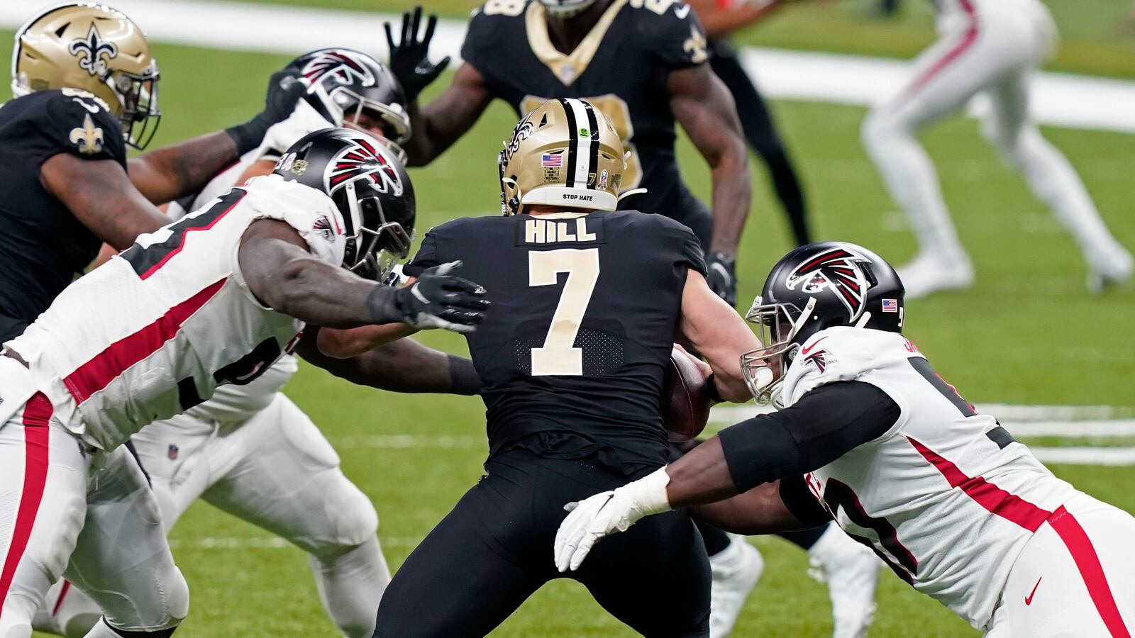 New Orleans Saints quarterback Taysom Hill (7) is sacked by Atlanta Falcons defensive end Allen Bailey (left) and defensive tackle Grady Jarrett in the first half Sunday, Nov. 22, 2020, in New Orleans. (Butch Dill/AP)