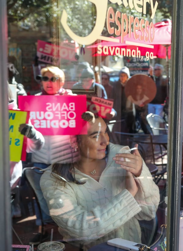 Larissa Leigh claps as abortion-rights supporters march past Gallery Espresso during the "Bigger Than Roe" rally and march on Saturday, January 20, 2023.