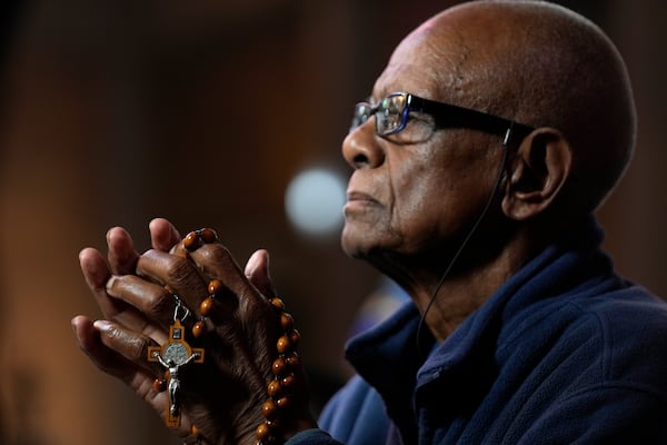 A man holds rosary beads during a spiritual celebration praying for the health of Pope Francis, at The Cathedral of Christ the King in Johannesburg, South Africa, Sunday, March 2, 2025. (AP Photo/Themba Hadebe)