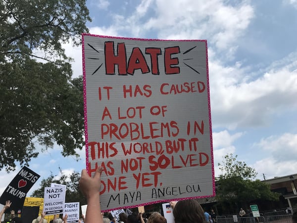 Counterprotesters at the Dahlonega rally had to go through a security checkpoint. Among their signs was one like this with a quote against hate attributed to the late writer Maya Angelou. (Photo: Rosalind Bentley/AJC)