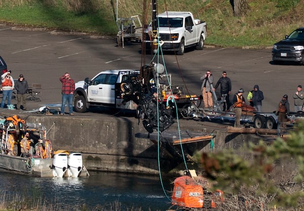 The Hood River County Sheriff’s Office and a team of divers retrieve a vehicle from the Columbia River, Friday, March 7, 2025, in Cascade Locks, Ore., that they believe the Martin family drove when they disappeared in 1958. (Beth Nakamura/The Oregonian via AP)