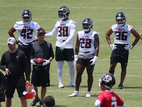 Falcons running backs Caleb Huntley (from left), Qadree Ollison, Mike Davis and Tony Brooks-James get in some work during organize team activities (OTAs) Tuesday, May 25, 2021, at the team training facility in Flowery Branch. (Curtis Compton / Curtis.Compton@ajc.com)