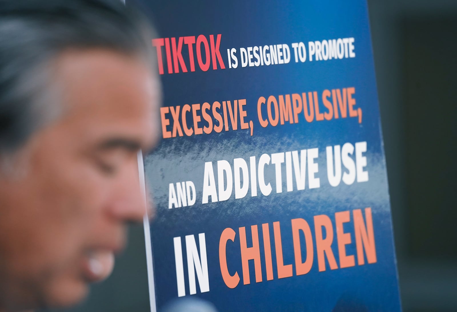 A poster criticizing TikTok is displayed as California Attorney General Rob Bonta spoke at a news conference this week.