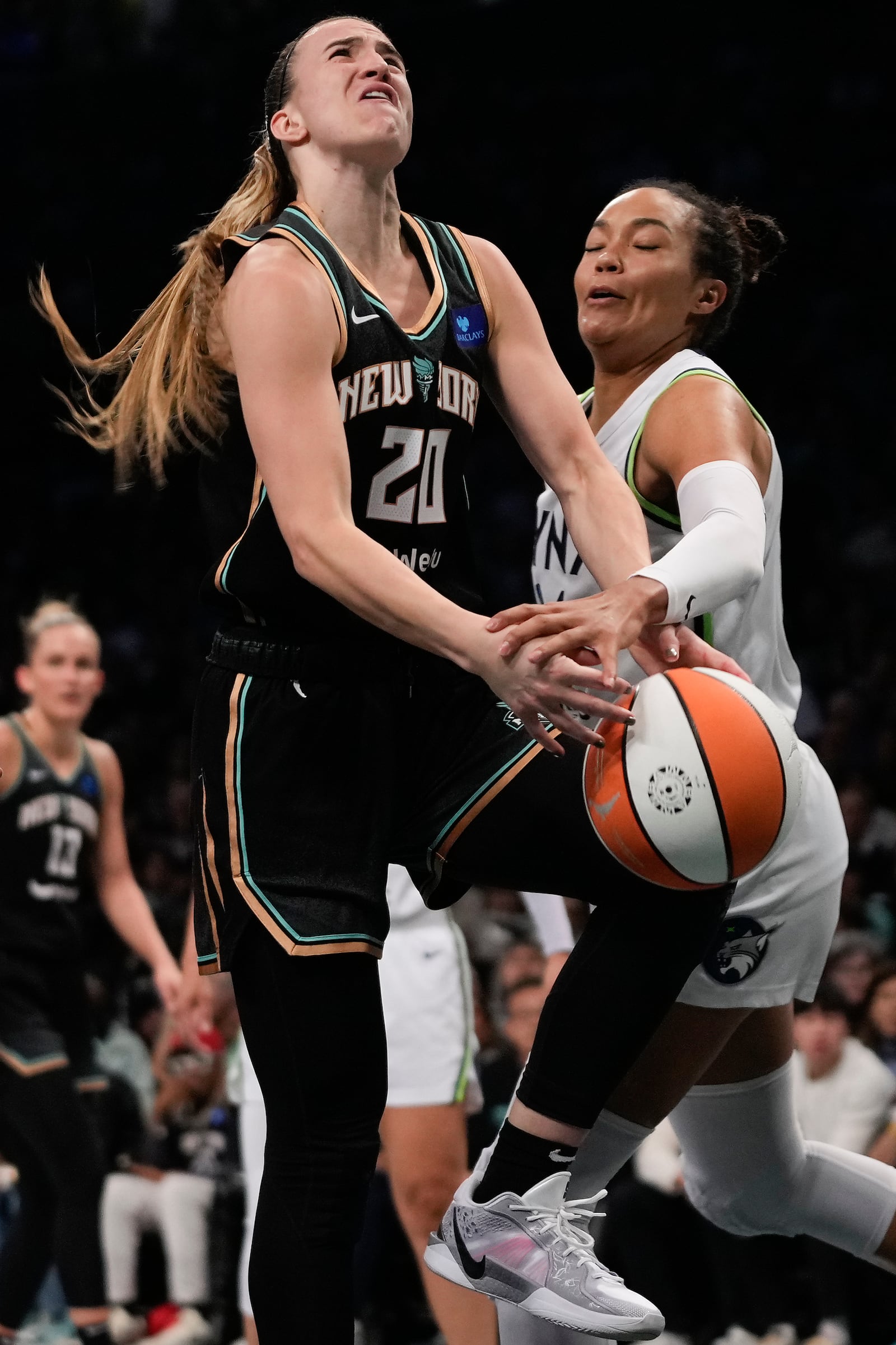 New York Liberty guard Sabrina Ionescu (20) is fouled by Minnesota Lynx forward Napheesa Collier (24) during the first quarter of Game 5 of the WNBA basketball final series, Sunday, Oct. 20, 2024, in New York. (AP Photo/Pamela Smith)