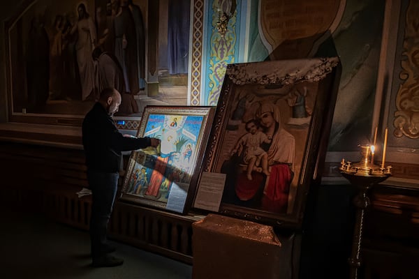 A man prays in front of an icon inside an Orthodox Church in Kurakhove, Donetsk region, Ukraine, on Nov. 7, 2024. (AP Photo/Anton Shtuka)