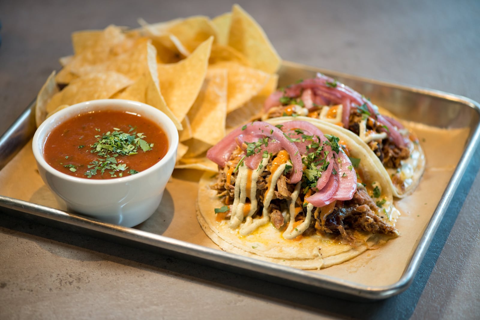  Pulled Pork tacos with Jalapeno Jicama slaw, cilantro, pickled red onion, avocado creme BBQ aioli. Photo credit- Mia Yakel.