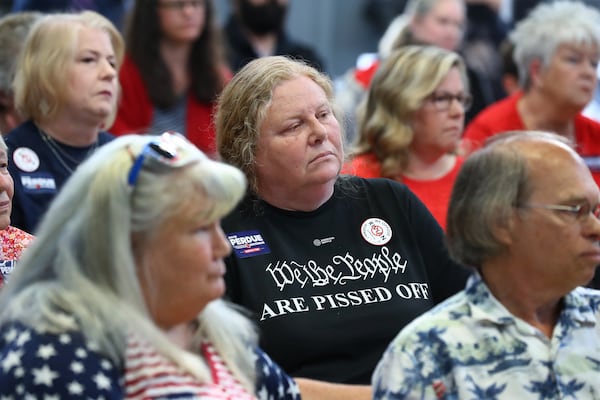 Rivian opponent Marcia Stephens, Rutledge, center, listens intently while the Site Design and Environmental committee takes public comments concerning the planned $5 billion Rivian electric vehicle plant on Monday, April 18, 2022, in Monroe.    “Curtis Compton / Curtis.Compton@ajc.com”