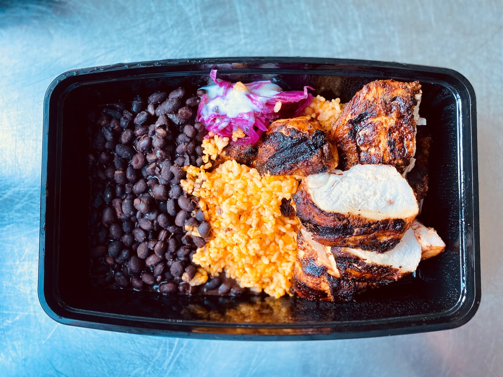 Bar Mercado’s grilled chicken is served with beans, rice and Salvadoran slaw. Wendell Brock for The Atlanta Journal-Constitution