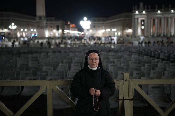 A nun prays during a rosary prayer for Pope Francis' health in St. Peter's Square at the Vatican, Thursday, Feb. 27, 2025. (AP Photo/Alessandra Tarantino)