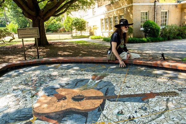 The Japanese art of kintsugi refers to a technique of repairing porcelain and pottery in which the breaks aren't disguised but instead are highlighted with powdered gold, silver or platinum. Artist Jason Evers Johnson adapted that concept to a larger scale project: breaking his monumental mosaic of Blind Willie McTell into pieces and moving it to the Little Five Points Community Center.  (Jenni Girtman for The Atlanta Journal-Constitution)