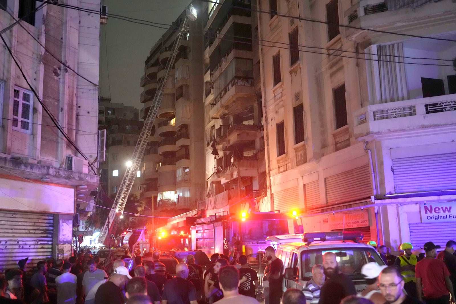 Rescue workers on a crane check a destroyed building hit by an Israeli airstrike in central Beirut, Lebanon, Thursday, Oct. 10, 2024. (AP Photo/Hassan Ammar)