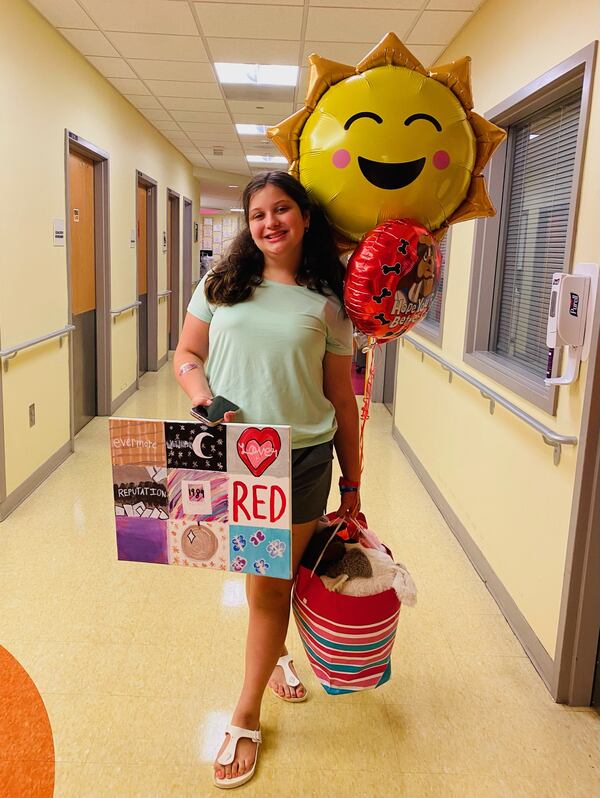 Audrey Koch, at age 12, ready for hospital discharge, with her Taylor Swift art project, gifts and balloons.
(Contributed)