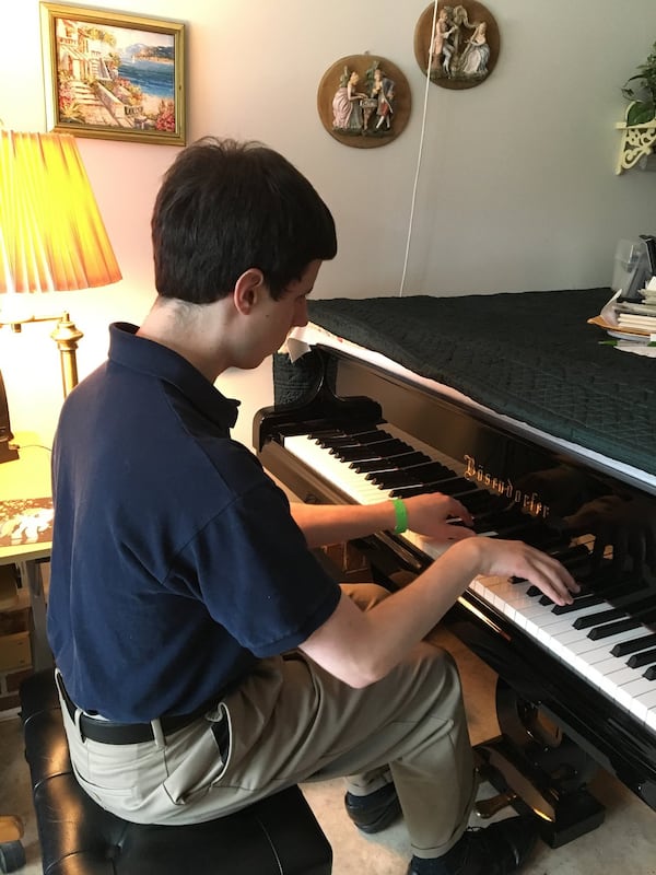 Timothy Jones performs Debussy’s Clair de Lune at his Norcross home on a recent afternoon. Contributed by Frank Reddy