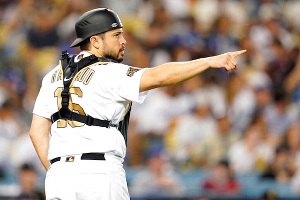 National League catcher Travis d'Arnaud, of the Atlanta Braves, points from home plate during the eighth inning of the MLB All-Star baseball game against the American League, Tuesday, July 19, 2022, in Los Angeles. (AP Photo/Abbie Parr)