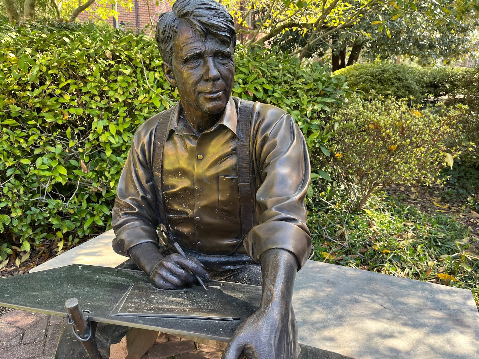 A sculpture by George W. Lundeen in the Alumnae Garden at Agnes Scott College in Decatur shows Robert Frost composing a poem. 
Phil Kloer for The Atlanta Journal-Constitution