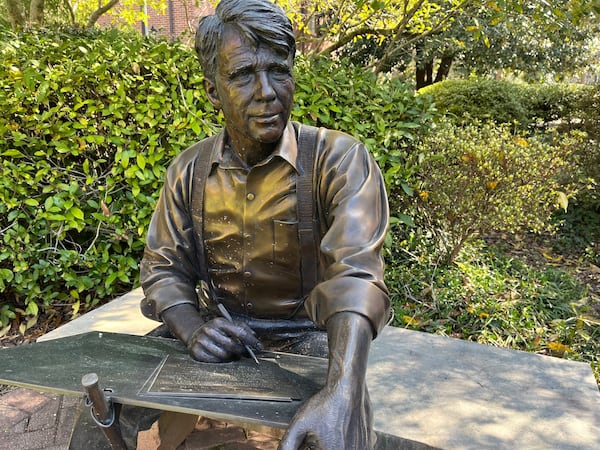 A sculpture by George W. Lundeen in the Alumnae Garden at Agnes Scott College in Decatur shows Robert Frost composing a poem. 
Phil Kloer for The Atlanta Journal-Constitution