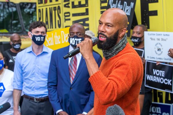 Rapper Common speaks Tuesday on behalf of Democratic U.S. Senate candidates Raphael Warnock, center, and Jon Ossoff during a campaign event in Jonesboro. ERIK LESSER / EUROPEAN PRESSPHOTO AGENCY