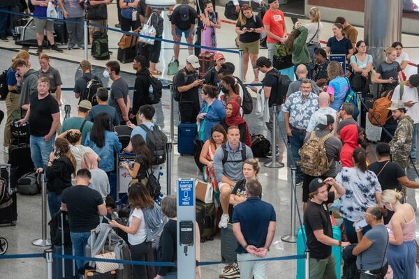 Passengers wait for their flights inside the south terminal in Hartsfield-Jackson Atlanta International Airport in Atlanta on Sunday, July 21, 2024.  (Ziyu Julian Zhu / AJC)