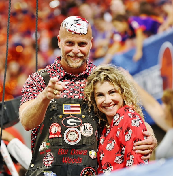 Mike Woods Jr., known as Little Mike Woods, and his wife, Christine Woods, at Mercedes-Benz Stadium in Atlanta for the Georgia Bulldogs' season opener against Clemson on Aug. 31, 2024. Woods is keeping alive the family tradition of painting his bald head with the UGA logo. (Photo courtesy of Mike Woods)