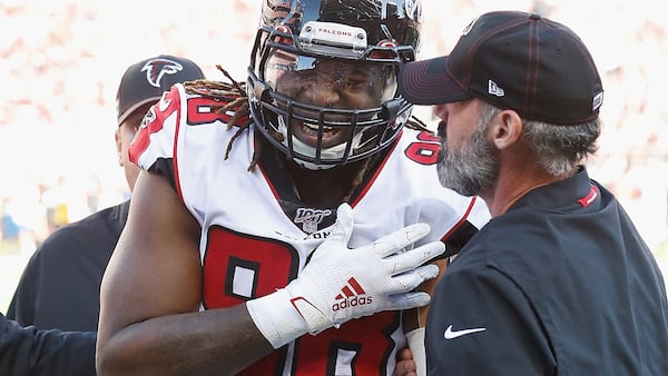 Falcons defensive end Takkarist McKinley (98) is assisted from the field after sustaining a shoulder injury in the first quarter against the San Francisco 49ers Sunday, Dec. 15, 2019, at Levi's Stadium in Santa Clara, Calif.