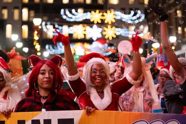 Janelle Allayah, with Beltline Cosplay cheers during the Christmas parade and tree lighting at Atlantic Station in Atlanta on Saturday, Nov. 23, 2024.   Ben Gray for the Atlanta Journal-Constitution