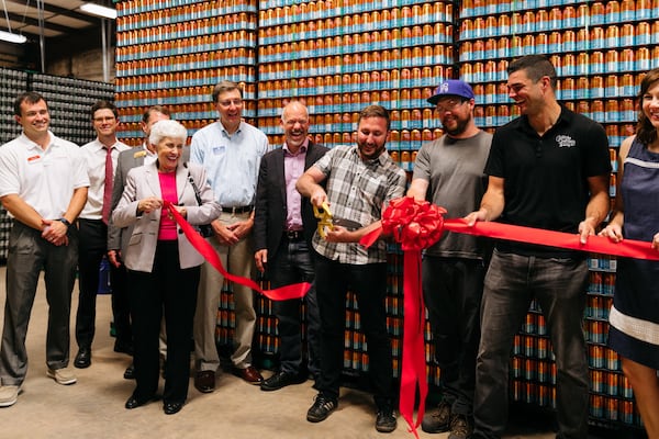 Creature Comforts head brewer David Stein, brewmaster Adam Beauchamp and CEO Chris Herron celebrate the grand opening of the brewery’s facility at Southern Mill in Athens earlier this year with a ribbon-cutting joined by Athens-Clarke County Mayor Nancy Denson, Mayor-elect Kelly Girtz and commissioners. CONTRIBUTED BY CREATURE COMFORTS BREWING CO.