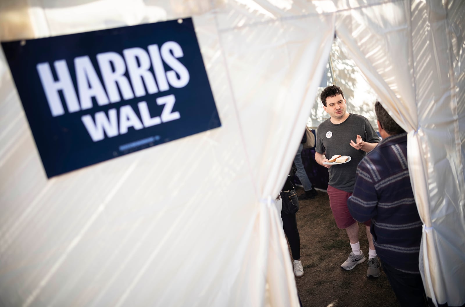 Adam Chaikof from Arlington, Va meets with other Kamala Harris supporters in a Sukkot in Bala Cynwyd, Pa on Sunday, Oct. 20, 2024. (AP Photo/Laurence Kesterson)