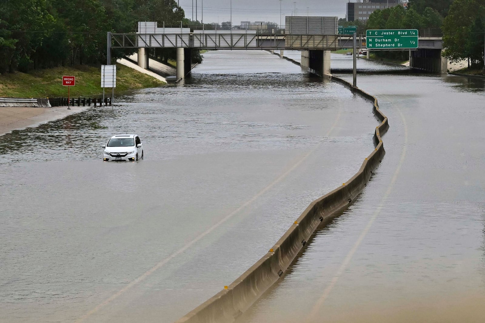 FILE - A vehicle is stranded in high waters on a flooded highway at Interstate 10 and Washington in Houston, on Monday, July 8, 2024, after Hurricane Beryl came ashore. (AP Photo/Maria Lysaker, File)