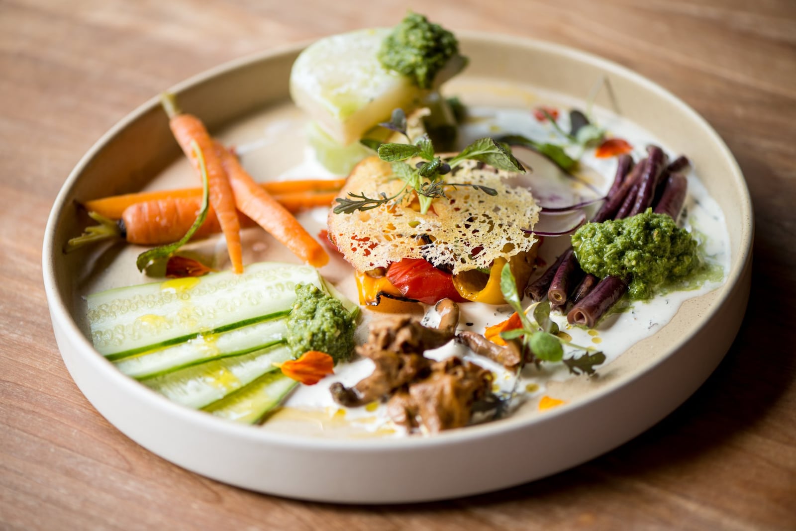 The Deer and the Dove Vegetables From Our Friends plate with raw, poached, and roasted vegetables, wasted pesto, and buttermilk. Photo credit- Mia Yakel.