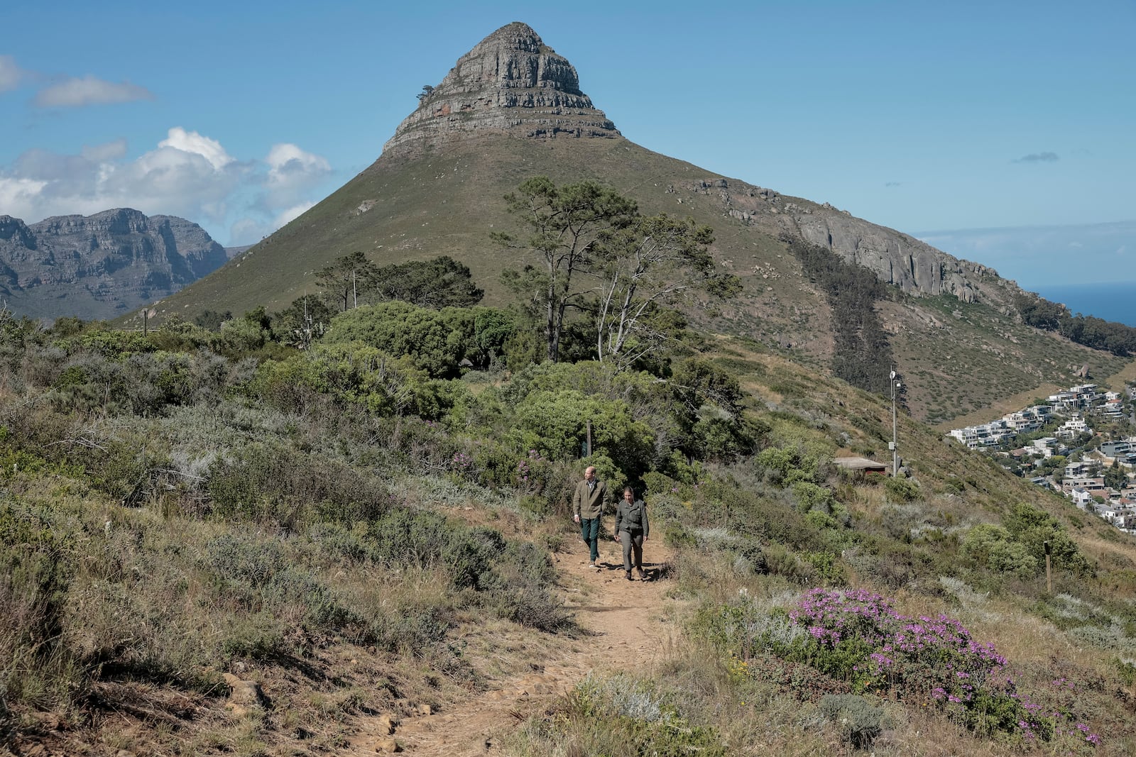 Britain's Prince William, left, talks with Park Manager for Table Mountain National Park Megan Taplin, right, while visiting Signal Hill in Cape Town, South Africa, Tuesday, Nov. 5, 2024. (Gianluigi Guercia/Pool via AP)